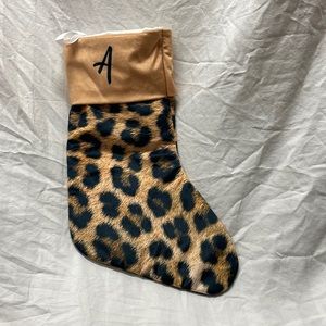 Leopard print Christmas stocking. Tan cuff w/letter “A” imprinted on both sides